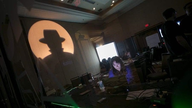 A Black Hat tech associate works during a July cybersecurity conference in Las Vegas. More than a dozen states have purchased some type of cyber insurance to protect themselves and taxpayers if they are victimized by hackers.