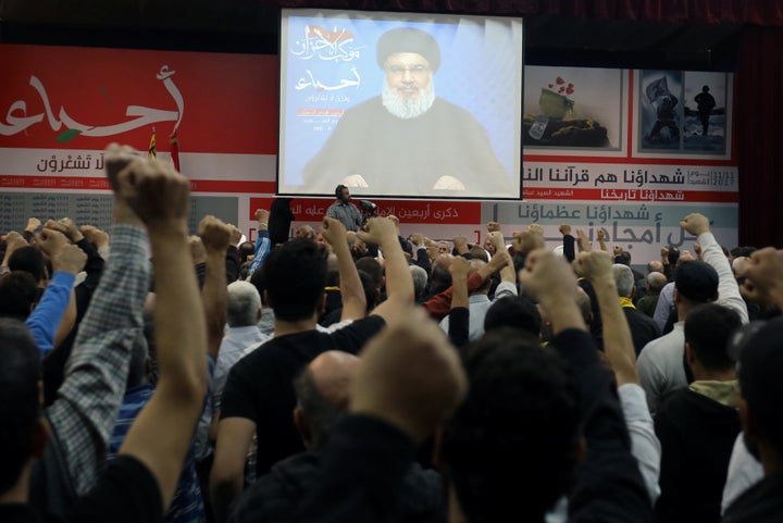 Lebanon's Hezbollah leader Sayyed Hassan Nasrallah is seen on a video screen as he addresses his supporters in Beirut, Lebano