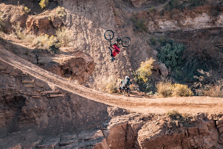 <p>Former Rampage winner, Brandon Semenuk appears to be backflipping only a few feet above the ground. In truth, he is 30 feet above his landing while soaring past a cliffside photographer.</p>