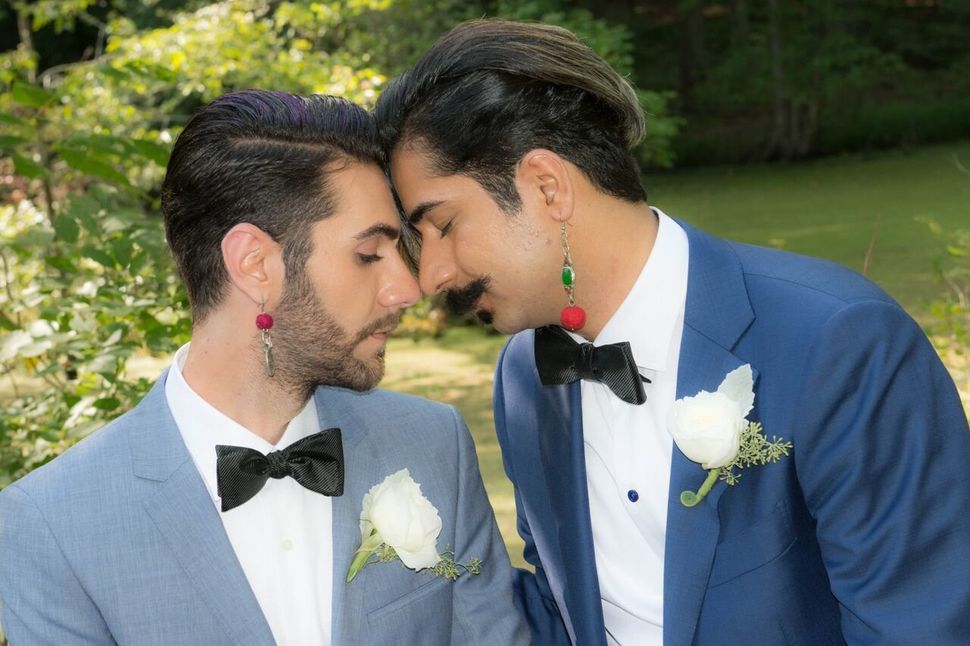Nima Nia (left) and Ramin Haghjoo pose for a portrait at their August wedding.