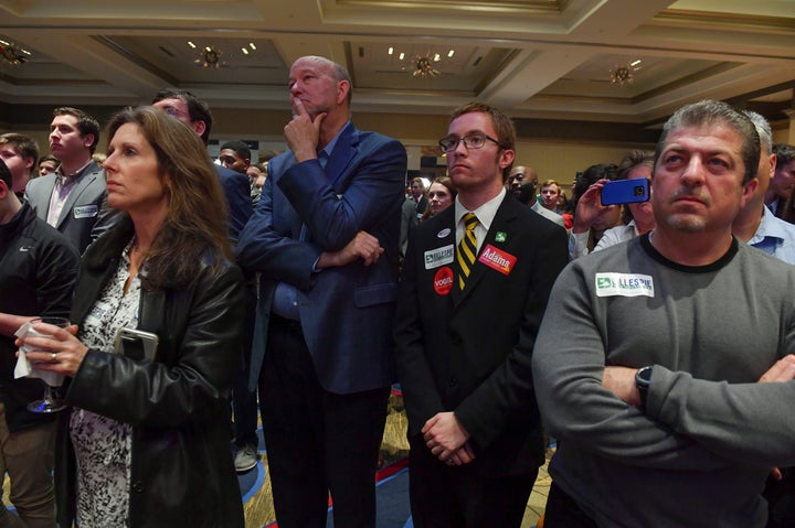 Supporters listen and look on as Virginia Republican gubernatorial candidate Ed Gillespie delivers his concession speech.