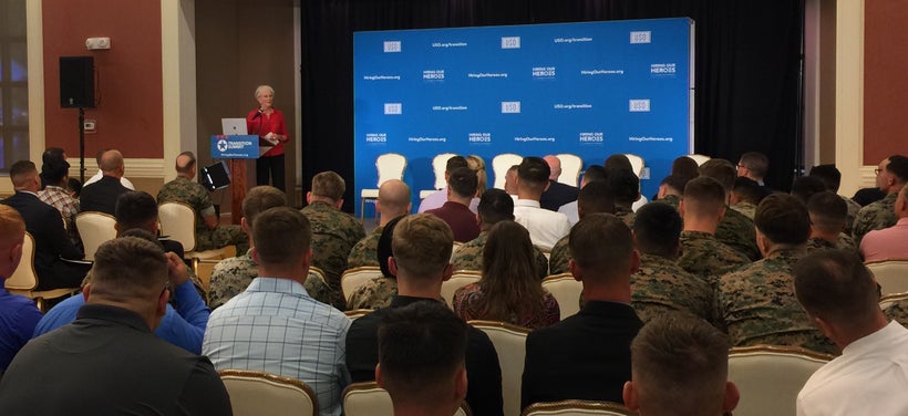 <em>Bonnie Amos speaks with transitioning service members, veterans, and military spouses at a Hiring Our Heroes event at Cam