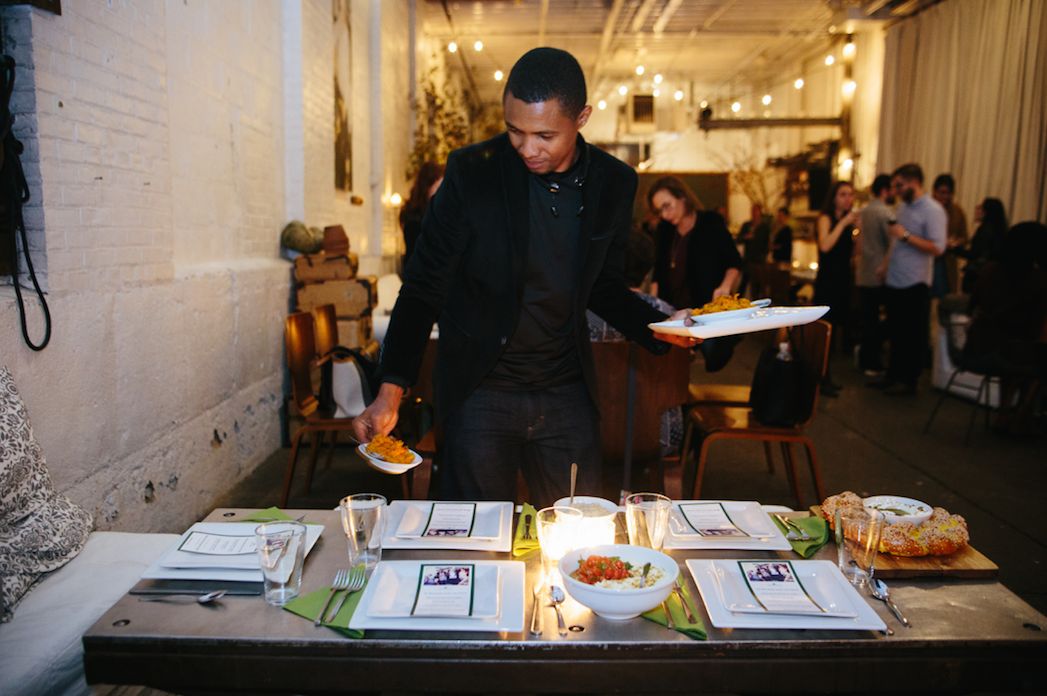 Boubacar Diallo serves food he prepared at an event for Emma's Torch.