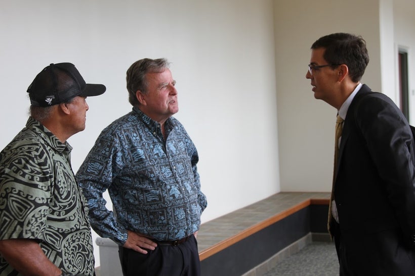 <em>H.A.P.A. President, Gary Hooser (center) confers with lawyer Lance Collins at the courthouse.</em> <em>On Hooser’s right