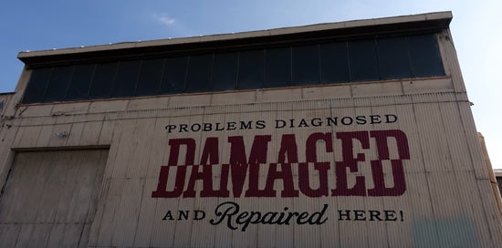 “Damaged” by Shepard Fairey” Outside of building 