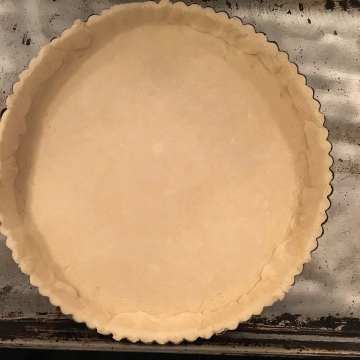 <p>Pastry-lined tart pan, patched where necessary around the edges</p>