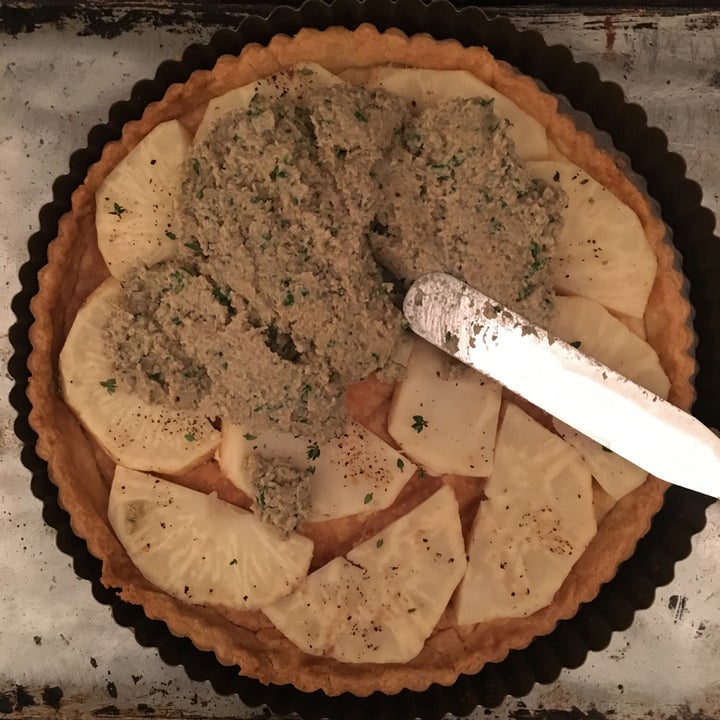 <p>Spread the onion-mushroom mixture over the celery root, filling in the gaps between pieces</p>