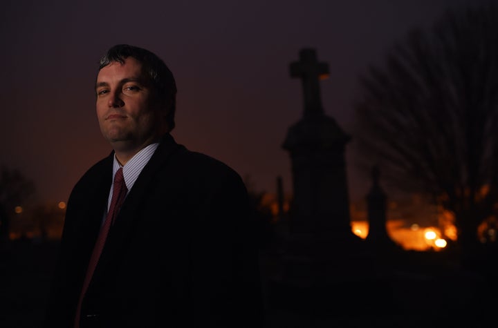 Here's Brett Talley posing for a portrait in a cemetery. In addition to being nominated to a lifetime court seat for some reason, he writes horror stories.