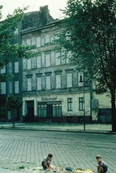 BOYS PLAYING BY FORMER BUTCHER SHOP BRICKED UP AS PART OF BERLIN WALL