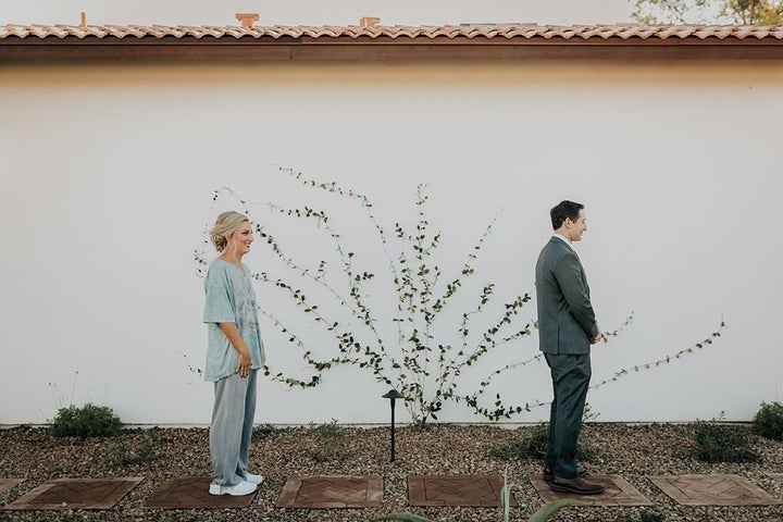 Newlyweds Erin and Ean Goldberg pose for hilarious first look wedding dress photo.