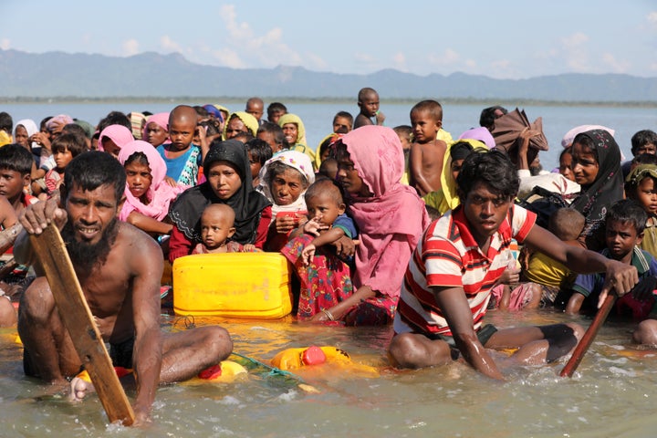 Rohingya refugees cross the Naf River with an improvised raft to reach to Bangladesh at Sabrang near Teknaf, Bangladesh Novem