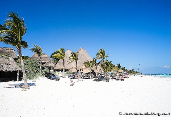 Tulum, Quintana Roo, beachfront, white sand beach, blowing palms, palapas (quintessential Tulum beach shot) Yucatan, Mexico.