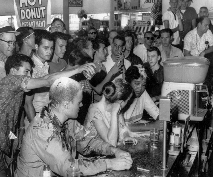 <p>White men abuse students during a sit-in at a Woolworth lunch counter in Jackson, Mississippi, protesting the store's "Whites-only" policy</p>