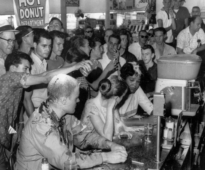 White men abuse students during a sit-in at a Woolworth lunch counter in Jackson, Mississippi, protesting the store's "Whites-only" policy