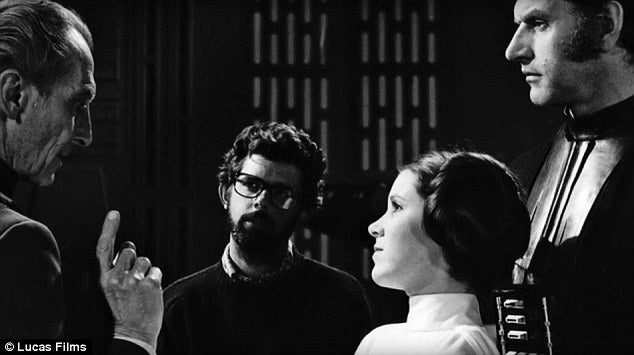 Left - Right: Peter Cushing, George Lucas, Carrie Fisher, and David Prowse, on the set of Star Wars, 1977