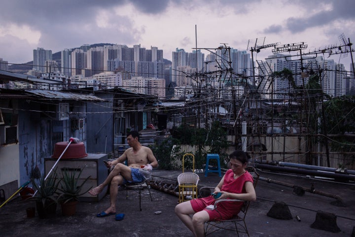 Migrant workers take a break after dinner outside a rooftop hut on June 3, 2017, in Hong Kong. Inequality has been on the rise for years, causing experts to worry about its destabilizing effects.