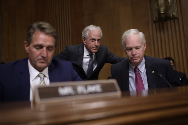 Sen. Bob Corker (R-Tenn.), center, chairman of the Senate Foreign Relations Committee, confers with Sen. Ron Johnson (R-Wis.), right, during a committee hearing Nov. 14 in Washington, D.C. Also pictured is Sen. Jeff Flake (R-Ariz.).