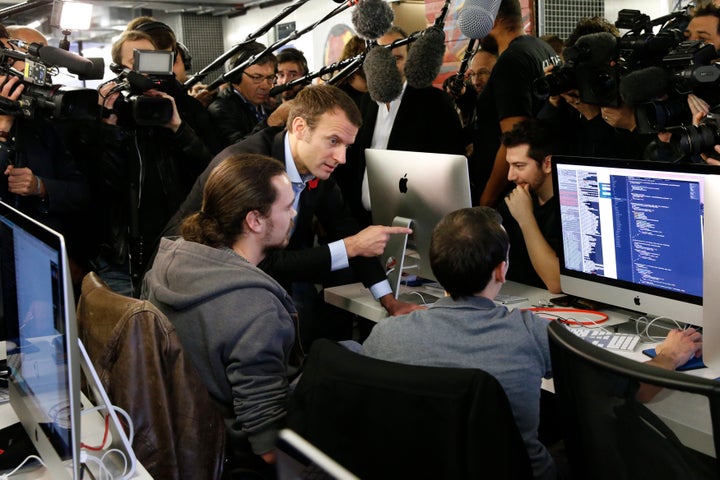 French president (then Economy Minister) Emmanuel Macron speaks to students during a visit to the 42 School campus in Paris in 2015.