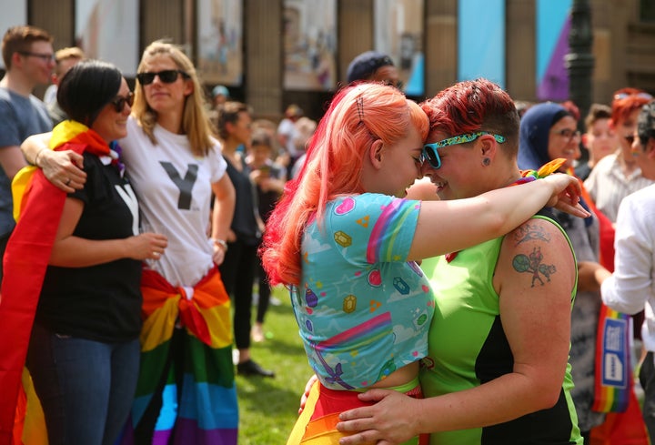 A couple hugs at the gathering at the state library.