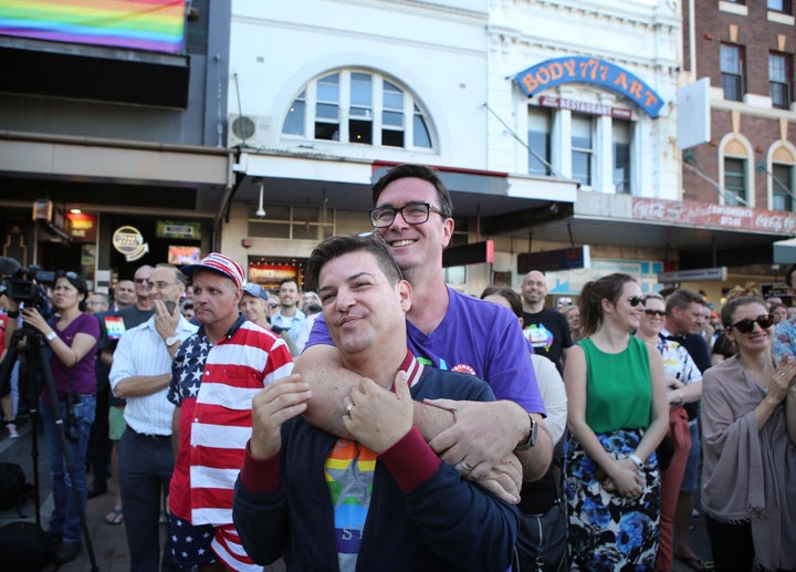 Victor De Sousa (left) and Chris Murray share the moment in Taylor Square in Sydney.