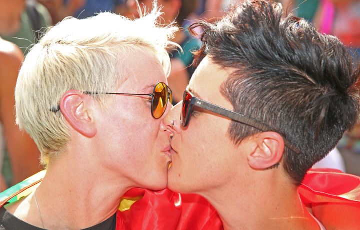 Rebecca Davies (left) and her partner, Paula Van Bruggen, kiss in Melbourne as the results of the poll on legalizing same-sex are announced.