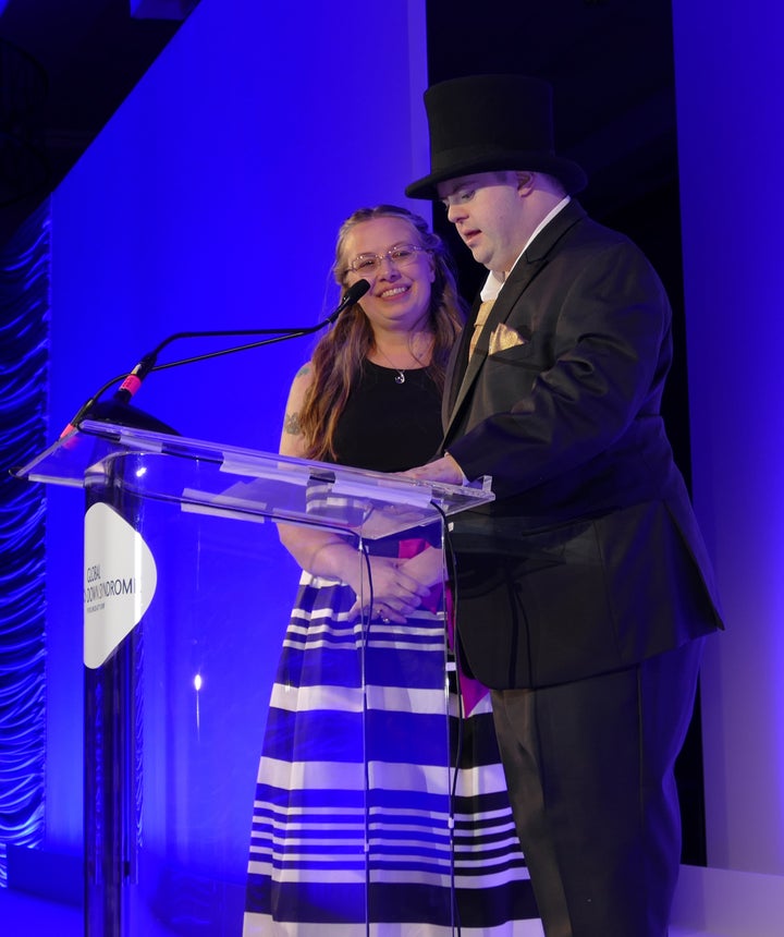 <p>Marcus Sikora at the podium and Mardra SIkora</p>