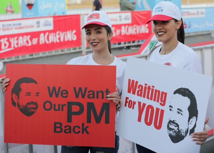 Hariri supporters at Beirut's annual marathon on Sunday hold up signs seeking his return to Lebanon.