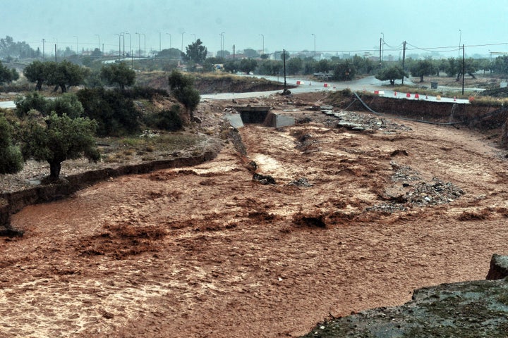 A picture shows damage and floodwaters in the town of Mandra.