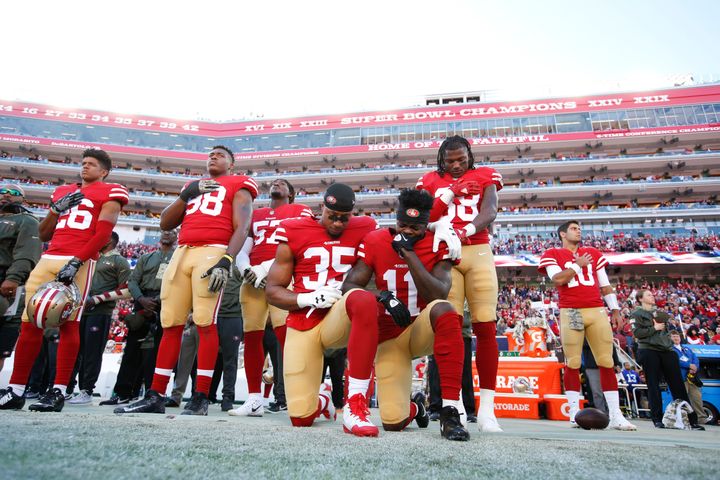 Reid, left, and teammate Marquise Goodwin, right, kneel during the anthem on Nov. 12, 2017, in Santa Clara, California.