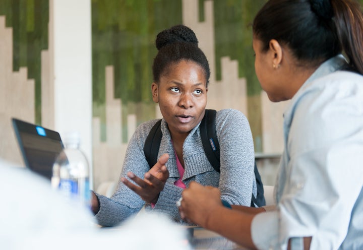 Hilta Tanis (left) talks to healthcare navigator Sandra Wells during an open enrollment event at the University of South Florida in Tampa.