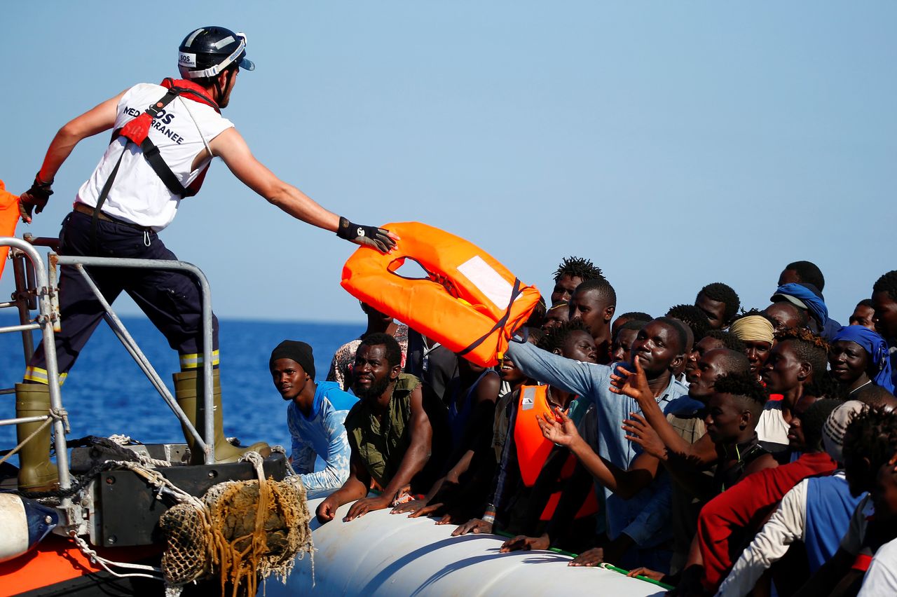 Migrants on a rubber boat are rescued by the SOS Mediterranee organization during a search-and-rescue operation off the Libyan Coast on Sept. 14.
