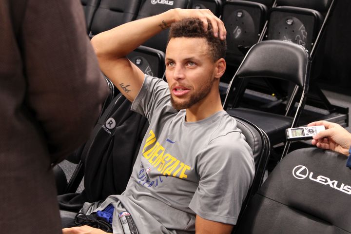 Golden State Warriors point guard Stephen Curry answers questions from the media following the morning shoot around.