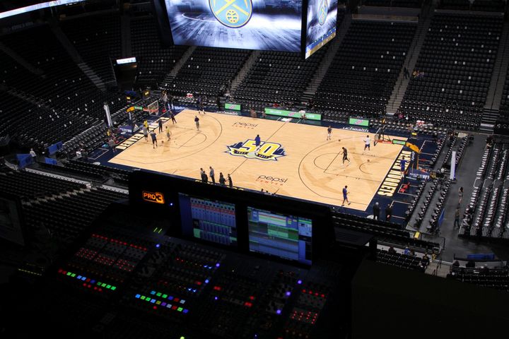 <p>The view from the Pepsi Center’s press box, which is located near the ceiling of the arena. In the immediate foreground is the audio and video control center.</p>