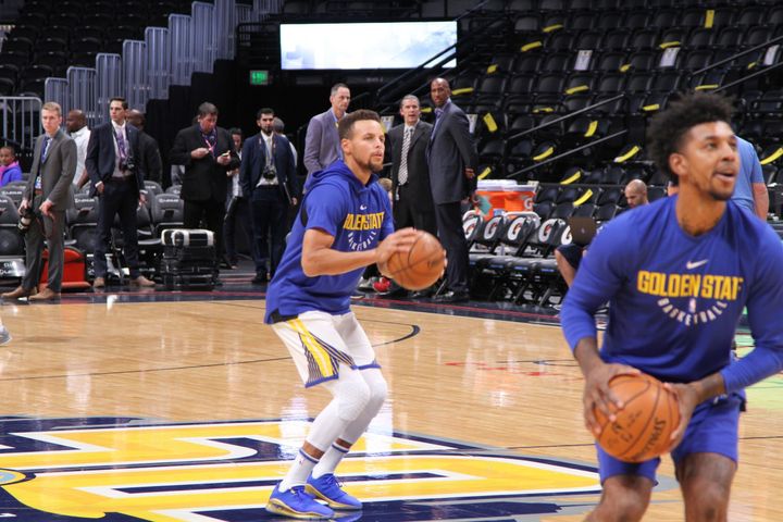 <p>Stephen Curry gets ready to launch a half court shot during pregame warmups. Newly acquired Golden State Warriors guard Nick Young is in the foreground.</p>
