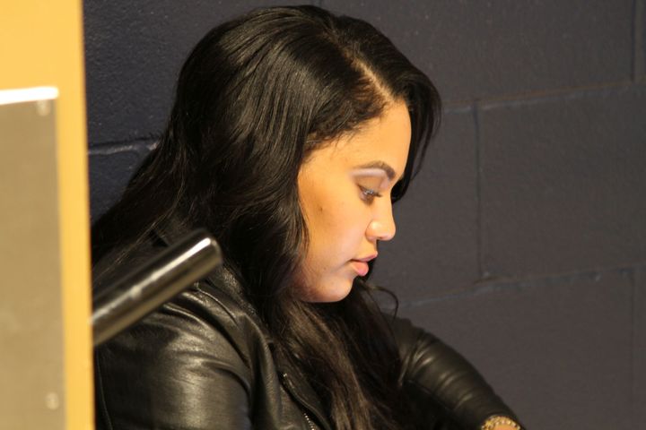 Ayesha Curry looks at her phone while waiting for her husband Stephen Curry outside the team locker room following the Warriors’ 127-108 victory.
