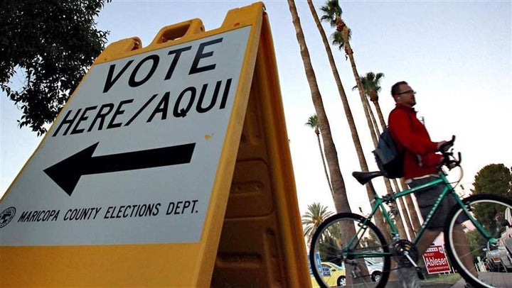 A sign directs voters to a polling station in Tempe, Ariz. Arizona’s two-tiered registration system is being challenged in co