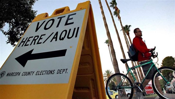 A sign directs voters to a polling station in Tempe, Ariz. Arizona’s two-tiered registration system is being challenged in court by the Campaign Legal Center, which argues the system disenfranchises thousands of voters.