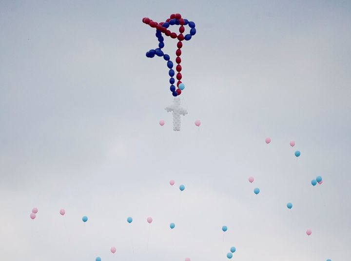 Balloons are released during a funeral service for members of the Holcombe family in Texas on Nov. 15.