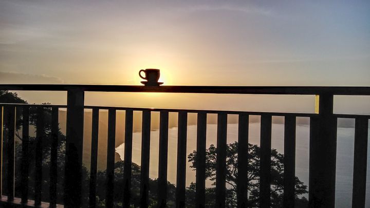 <p><em>Cafecito and a volcano lagoon sunrise, from Pacaya Lodge, on the crater above Laguna de Apoyo, Nicaragua.</em></p>