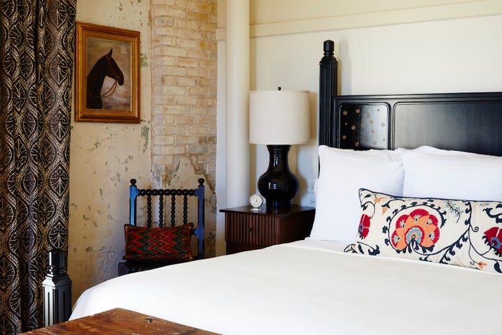 <p>Hotel Emma guest room featuring lacquered bed and custom linens. </p>