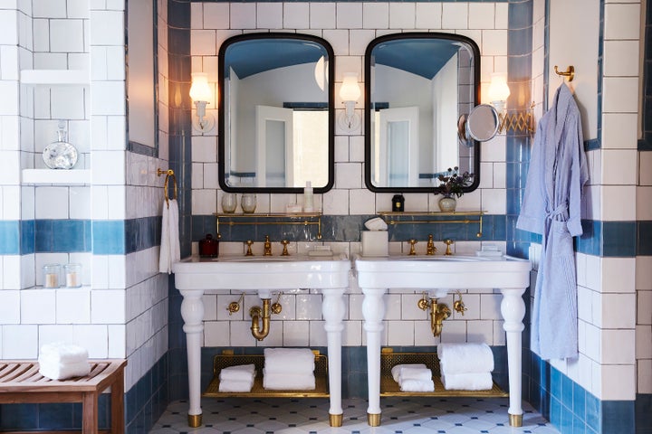 <p>Custom tiles by Roman and Williams cover the walls of each guest bath. </p>