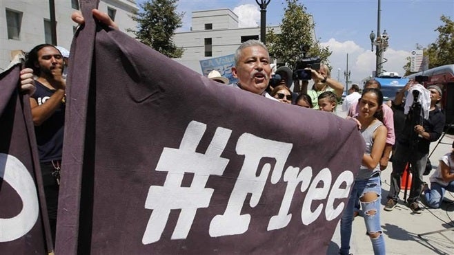 <p>Immigrants in downtown Los Angeles celebrate the release of a longtime resident from a federal immigrant detention center near the city. California and some cities are resisting a move to drastically increase the number of prison beds used to hold immigrants for possible deportation.</p>