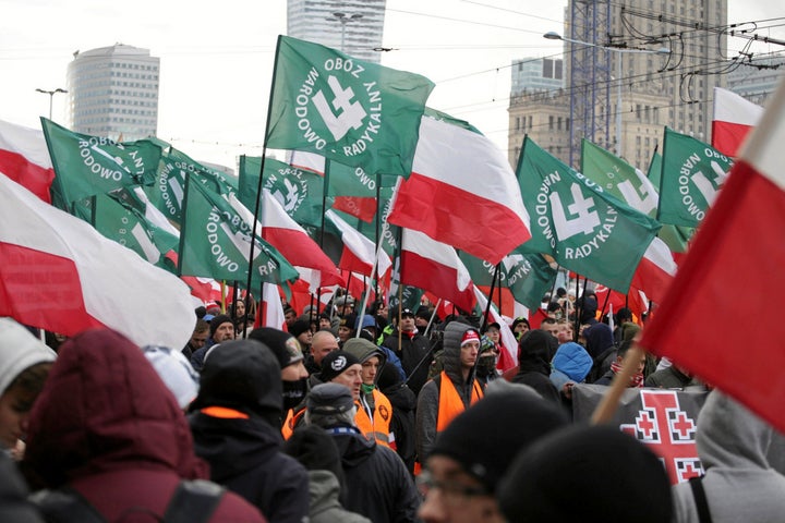 Protesters carry Polish flags and National Radical Camp flags during a rally organized by far-right, nationalist groups to mark the 99th anniversary of Polish independence in Warsaw, Poland, on Nov. 11, 2017.