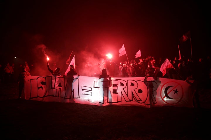 Protesters carry Polish flags and banners during the 2017 independence rally.