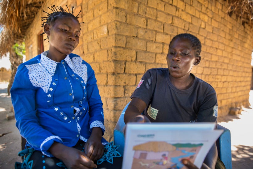Joelle Inamulongo (left) getting hygiene information from Adele (right), a community volunteer, or “Animateur,” trained by Co