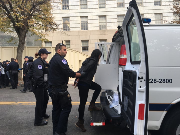 One of the arrested protesters is led away by U.S. Capitol Police.