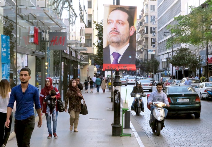A poster showing Saad al-Hariri is seen in Beirut, Lebanon on November 15, 2017. Words on the poster read, "We are all with y