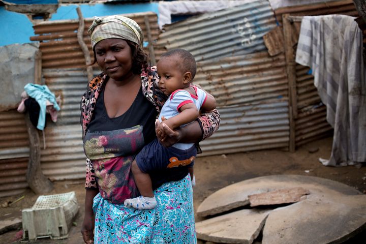  Yvonne Antonoia Mathe looks after her sister's eight-month-old boy Wagner at her home in Maputo, Mozambique, Thursday 28 September 2017. Yvonne's home is located alongside a road and with the rains her yard floods. Her open informal latrine is separated from the road by a single sheet of corrugated iron. She makes a living by selling vegetables from a stall at her house. 