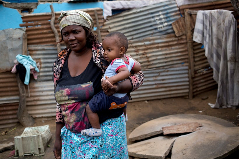 <em>Yvonne Antonoia Mathe looks after her sister's eight-month-old boy Wagner at her home in Maputo, Mozambique, Thursda