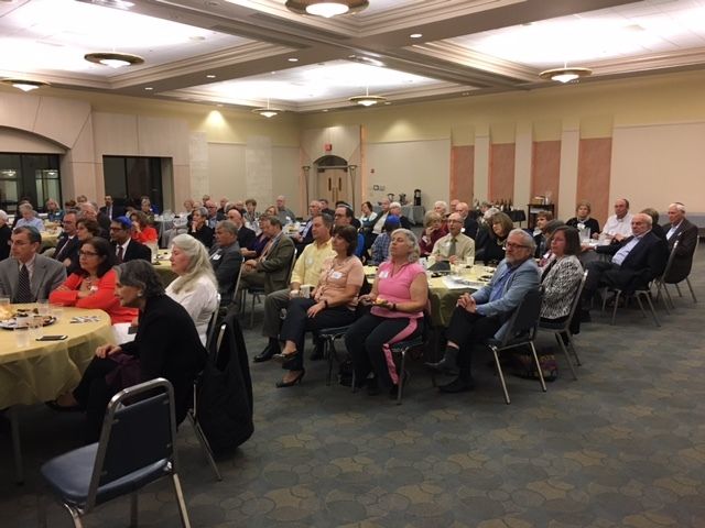 A full-house audience at Temple Beth Ami watches on as Ambassador Akbar Ahmed delivers his Shabbat dinner lecture on Jewish-Muslim relations. 